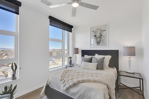a bedroom with a large bed and a ceiling fan