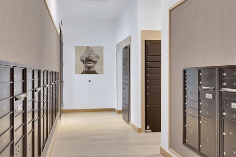 a hallway with lockers and a painting on the wall
