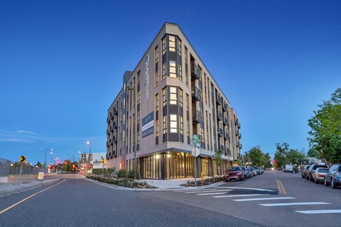 a building on the corner of a city street at night
