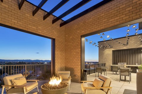 the patio has a fire pit and views of the city and the mountains