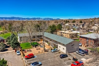 A parking lot with cars and a building in the background.