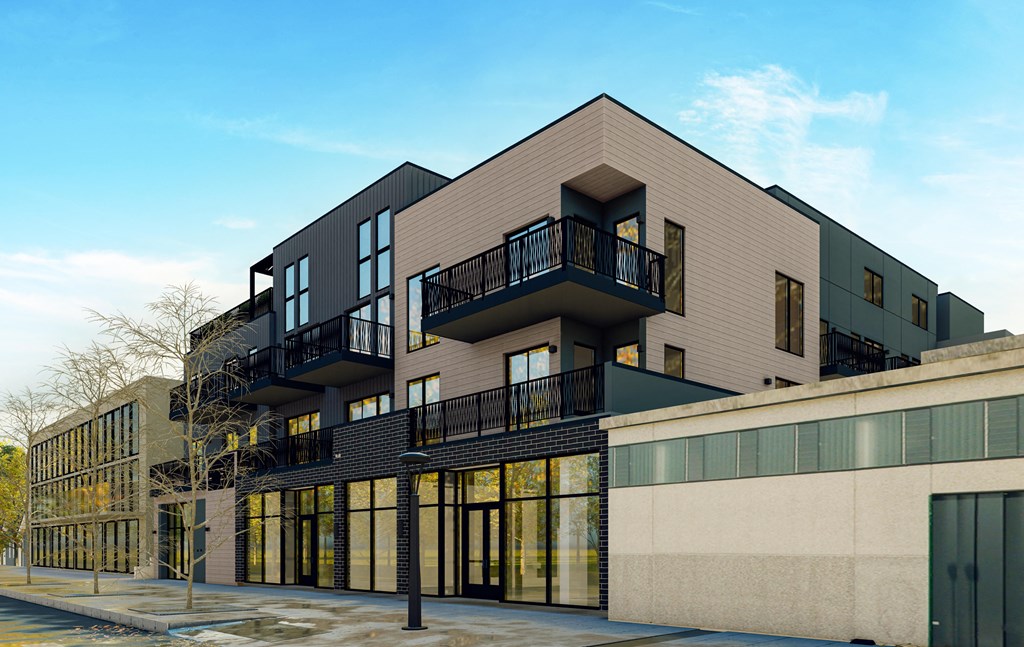 A modern building with a balcony and large windows.