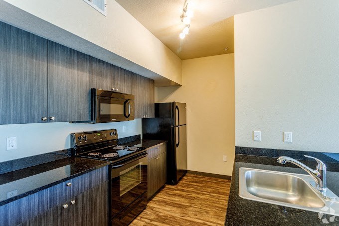 a kitchen with a stove microwave and sink