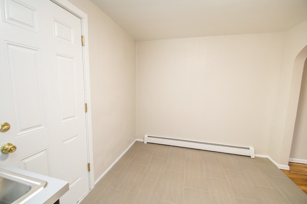 a empty room with a sink and a door