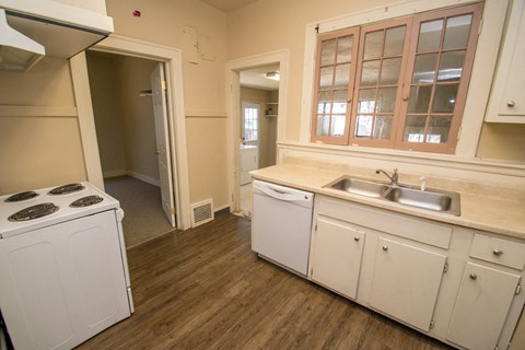 A small kitchen with a washing machine and a dishwasher.