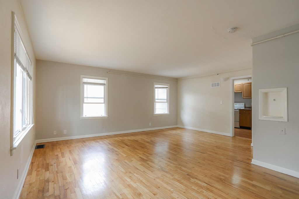 A room with wooden floors and white walls.