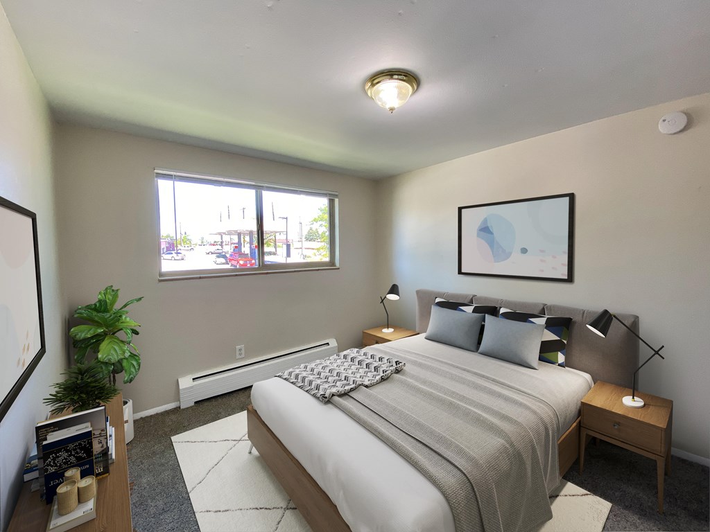 A bedroom with a large bed and a window overlooking a street.