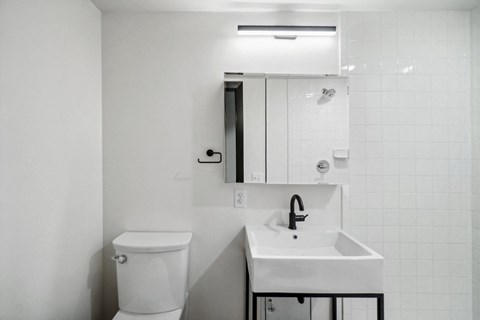 an empty bathroom with a sink and a toilet