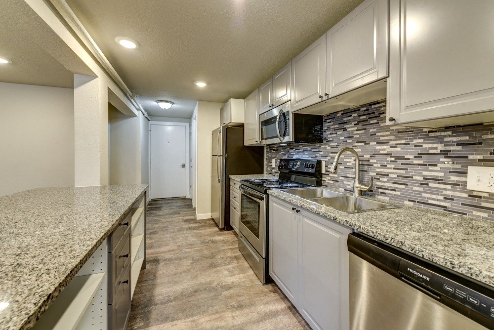 the spacious kitchen with granite counter tops and stainless steel appliances