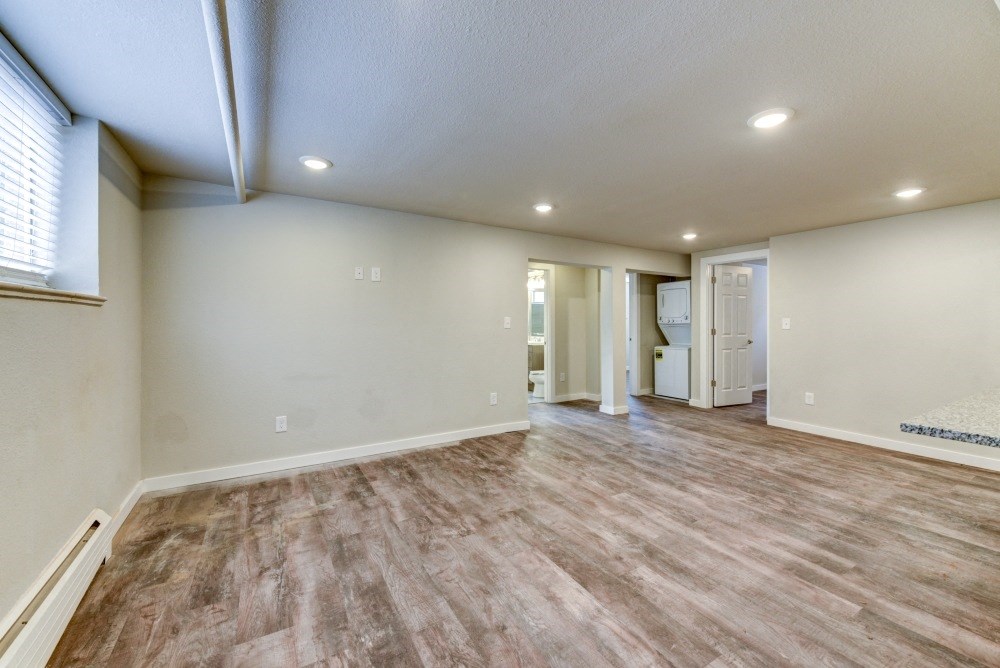 the spacious living room and kitchen in a new home