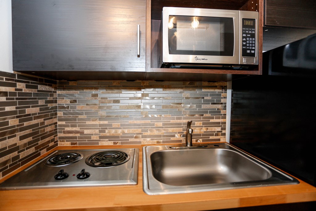 a small kitchen with a sink and a microwave