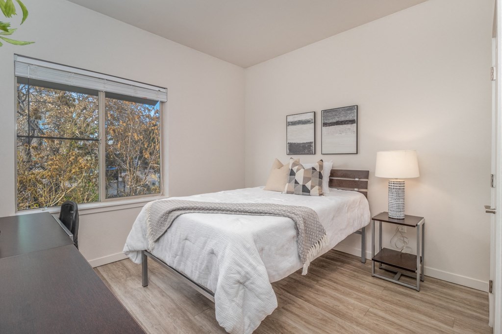 a bedroom with a bed and a large window