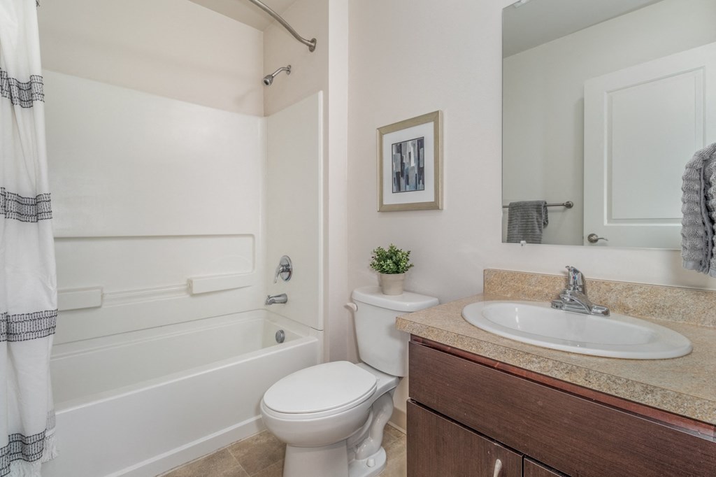 a bathroom with a sink toilet and a bath tub