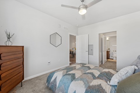A bedroom with a bed and a dresser.