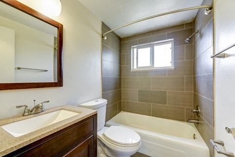 a bathroom with a sink toilet and a bath tub