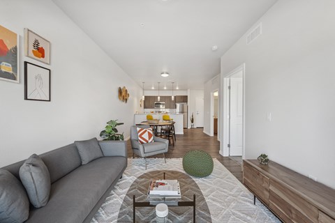 A living room with a grey sofa and a coffee table.