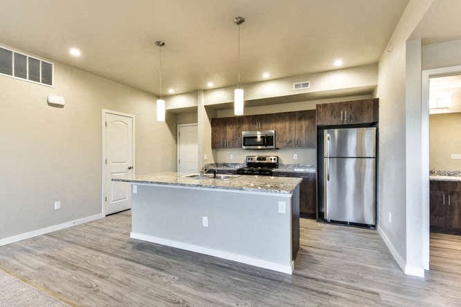 a kitchen with a counter top and a refrigerator