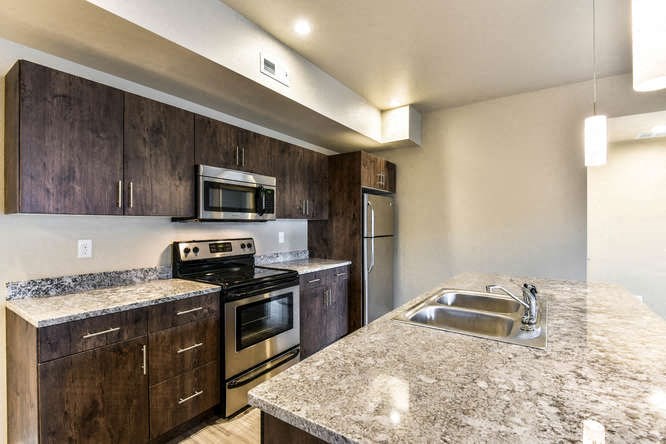 a kitchen with stainless steel appliances and granite counter tops