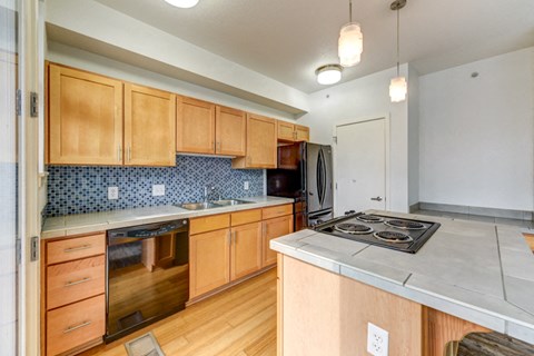 a kitchen with wooden cabinets and a stove and a sink