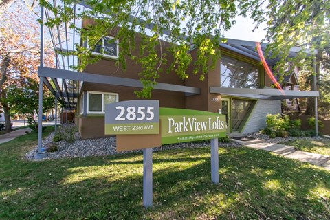 A brown sign with the number 2855 and the words Park View Lots in front of a building.