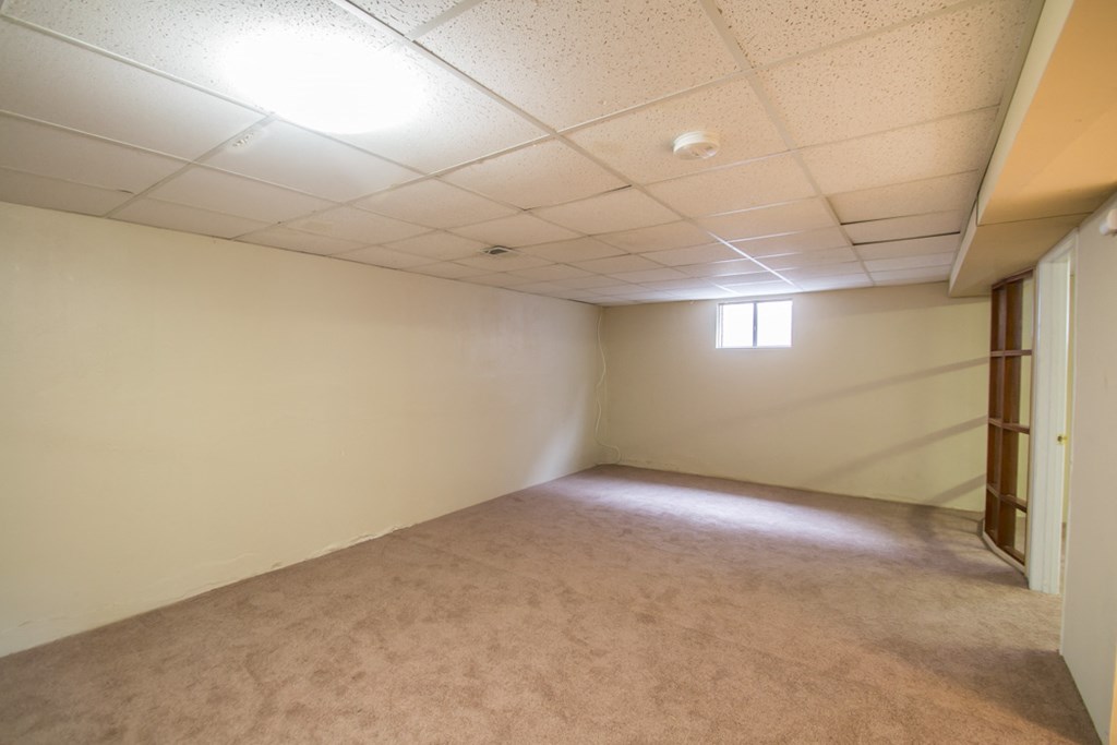 an empty room with a door and a window