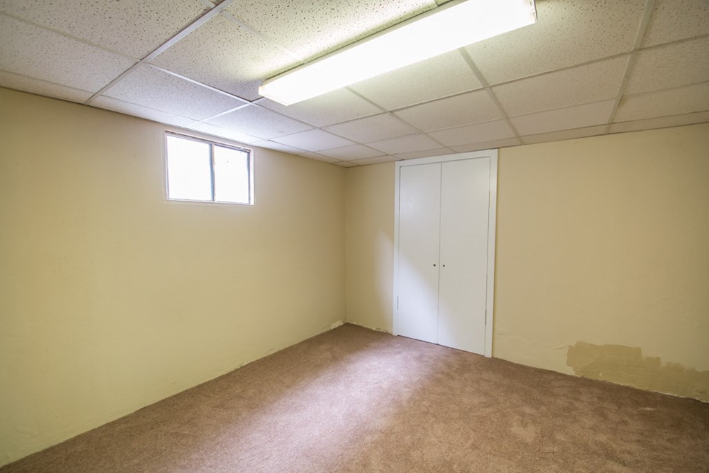 an empty room with a door and a window