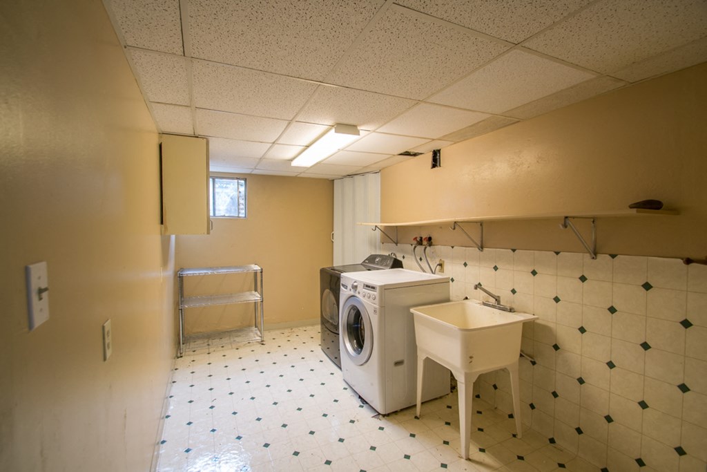 a laundry room with a washing machine in it