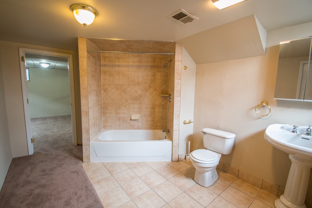 a bathroom with a toilet sink and a bath tub