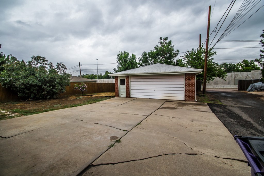 a small garage with a driveway in front of it