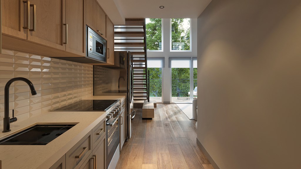 A kitchen with wooden cabinets and a black faucet.