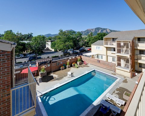 a view of a pool and a building with a mountain in the background