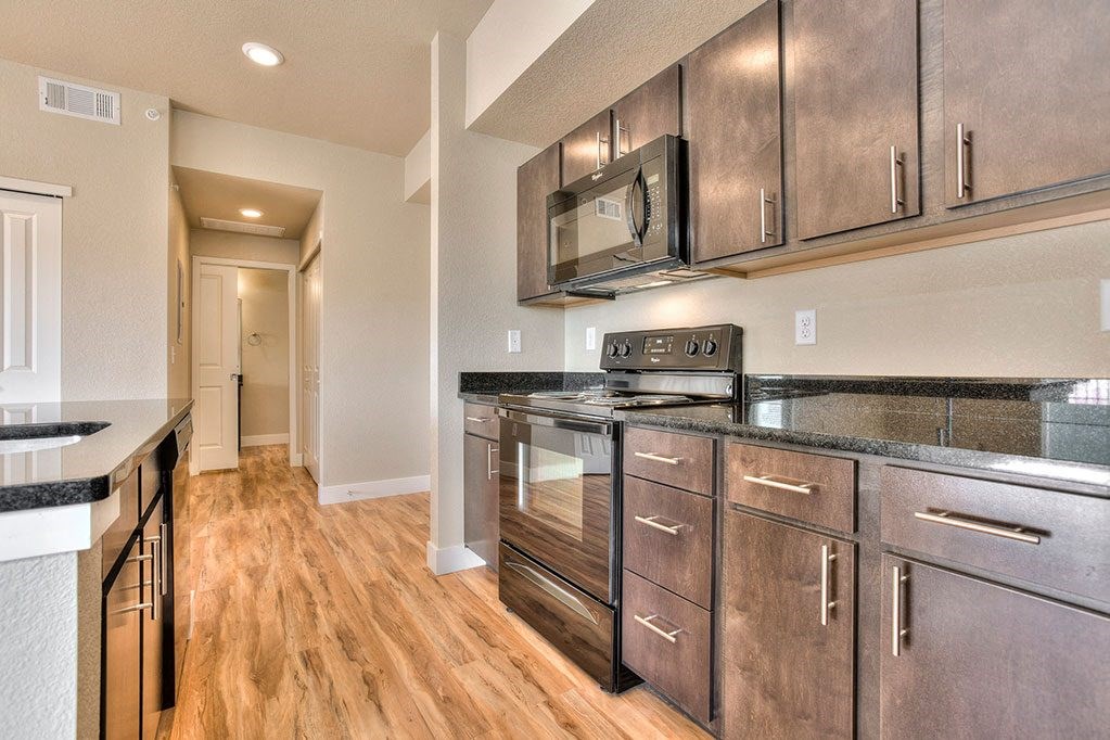 a kitchen with stainless steel appliances and a microwave