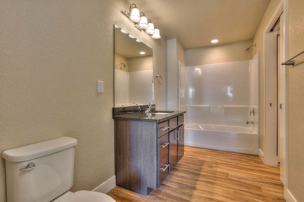 a bathroom with a toilet and a sink and a bath tub