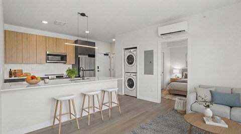 A modern kitchen with white cabinets and a wooden island.