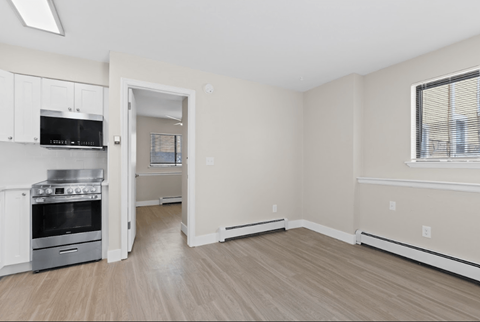 A kitchen with a stove top oven and microwave.
