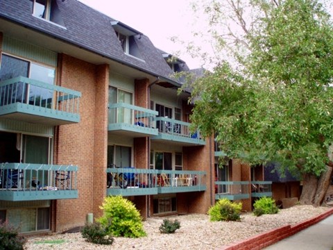 an apartment building with balconies and trees