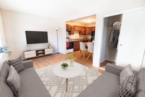 A living room with a grey couch and a white coffee table.