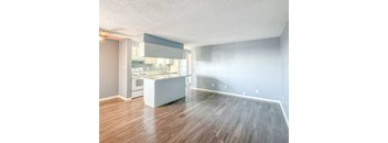A kitchen with a white island in the middle of the room.