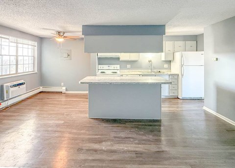 A kitchen with a large island in the middle of the room.