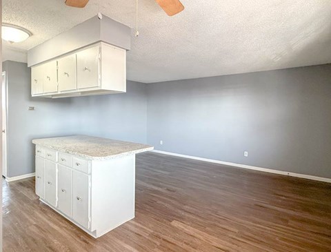 A room with a white cabinet and a wooden floor.