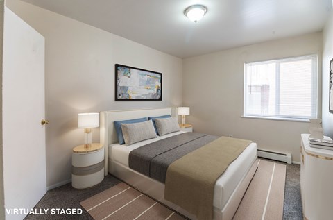 A bedroom with a bed, nightstands, and a painting on the wall.