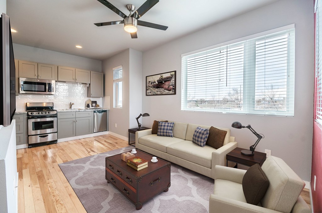 A living room with a white couch and a coffee table.