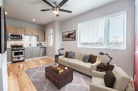 A living room with a white couch and a coffee table.