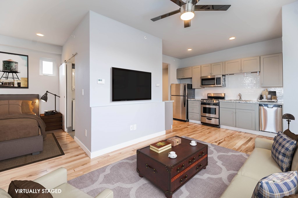 A modern living room with a flat screen TV mounted on the wall.