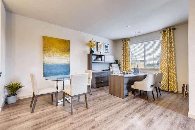 a living room and dining room with a table and chairs