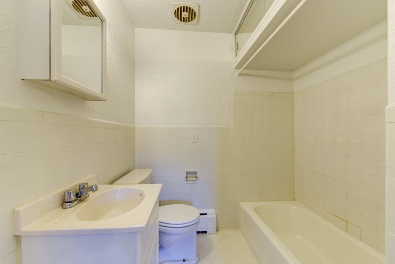 a bathroom with a sink toilet and a bath tub