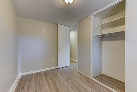 an empty room with white walls and a closet