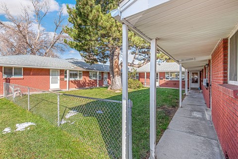 A residential area with houses and a fenced yard.