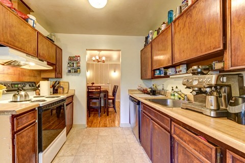 A kitchen with wooden cabinets and a sink.