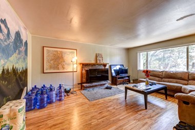 a living room with a fireplace and a large window